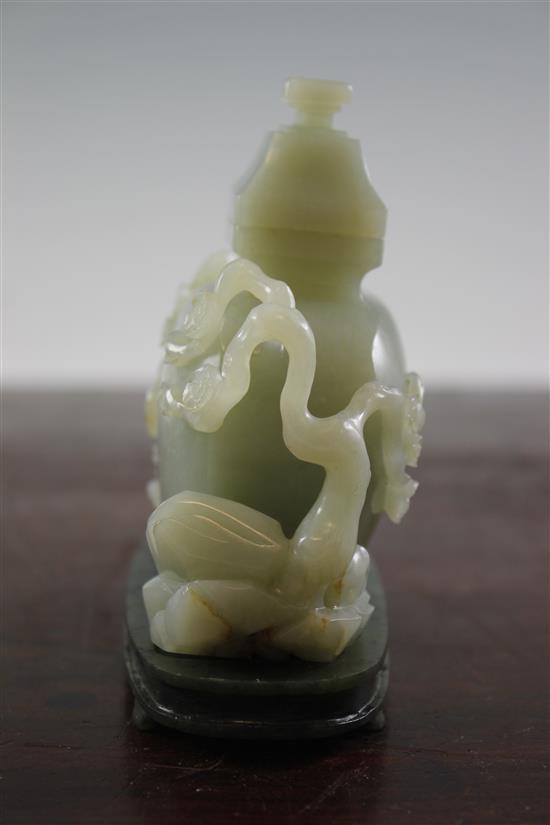 A Chinese pale celadon jade vase and cover, with spinach green jade stand, Qing dynasty or later, 4.3cm., width 13.5cm., fitted rosewoo